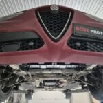 Front low-angle underside view of Alfa Romeo Stelvio before underbody protection installation