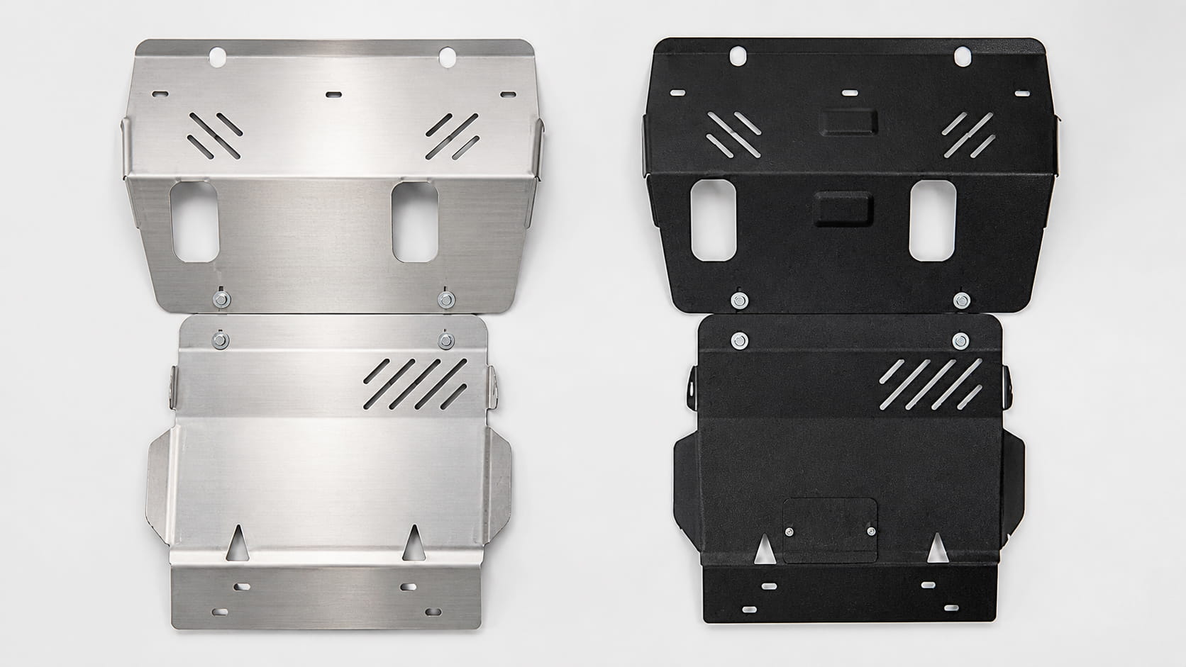 Steel and aluminium underbody skid plates side by side on a neutral background for material comparison