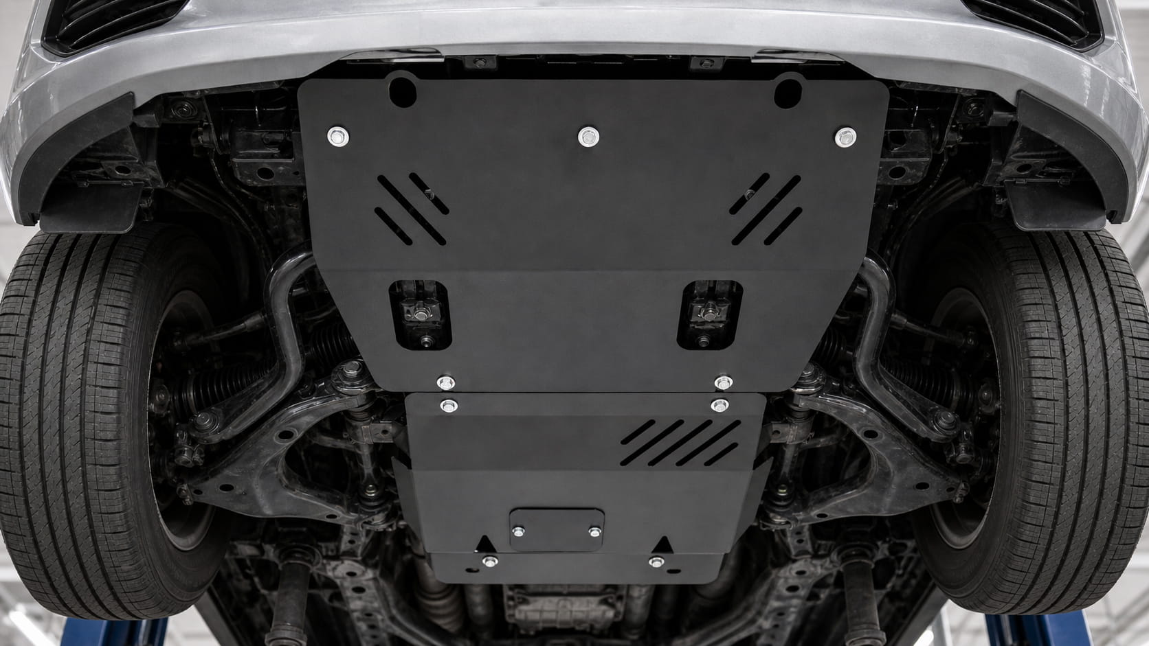 Underbody view of a vehicle with a heavy-duty steel skid plate installed to protect the engine