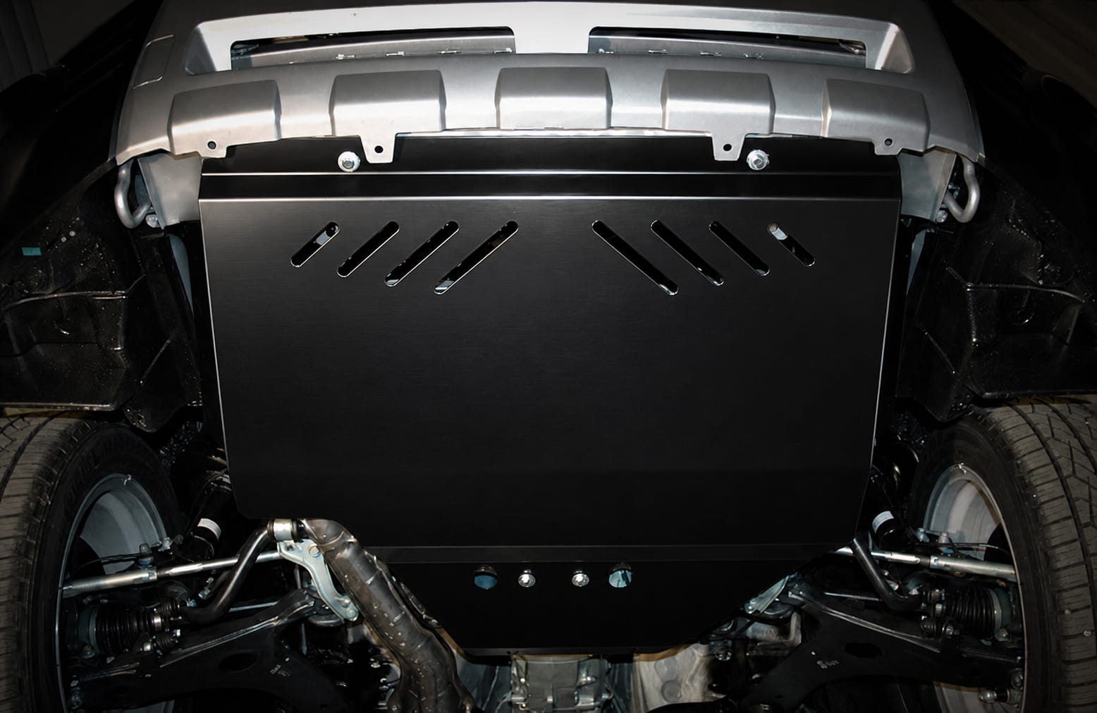 Metal engine skid plate installed under the front of a vehicle to protect the oil pan and lower engine components